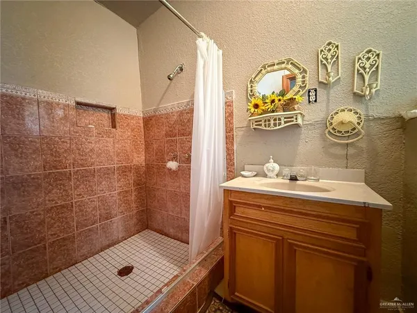 a bathroom with a sink a vanity and a shower