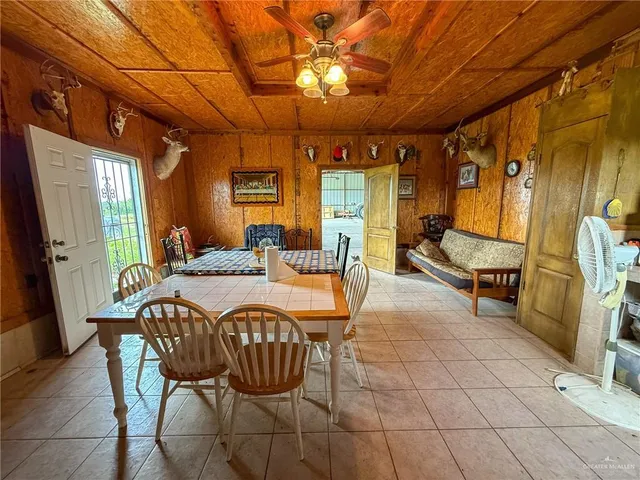 a dining room with furniture and a chandelier