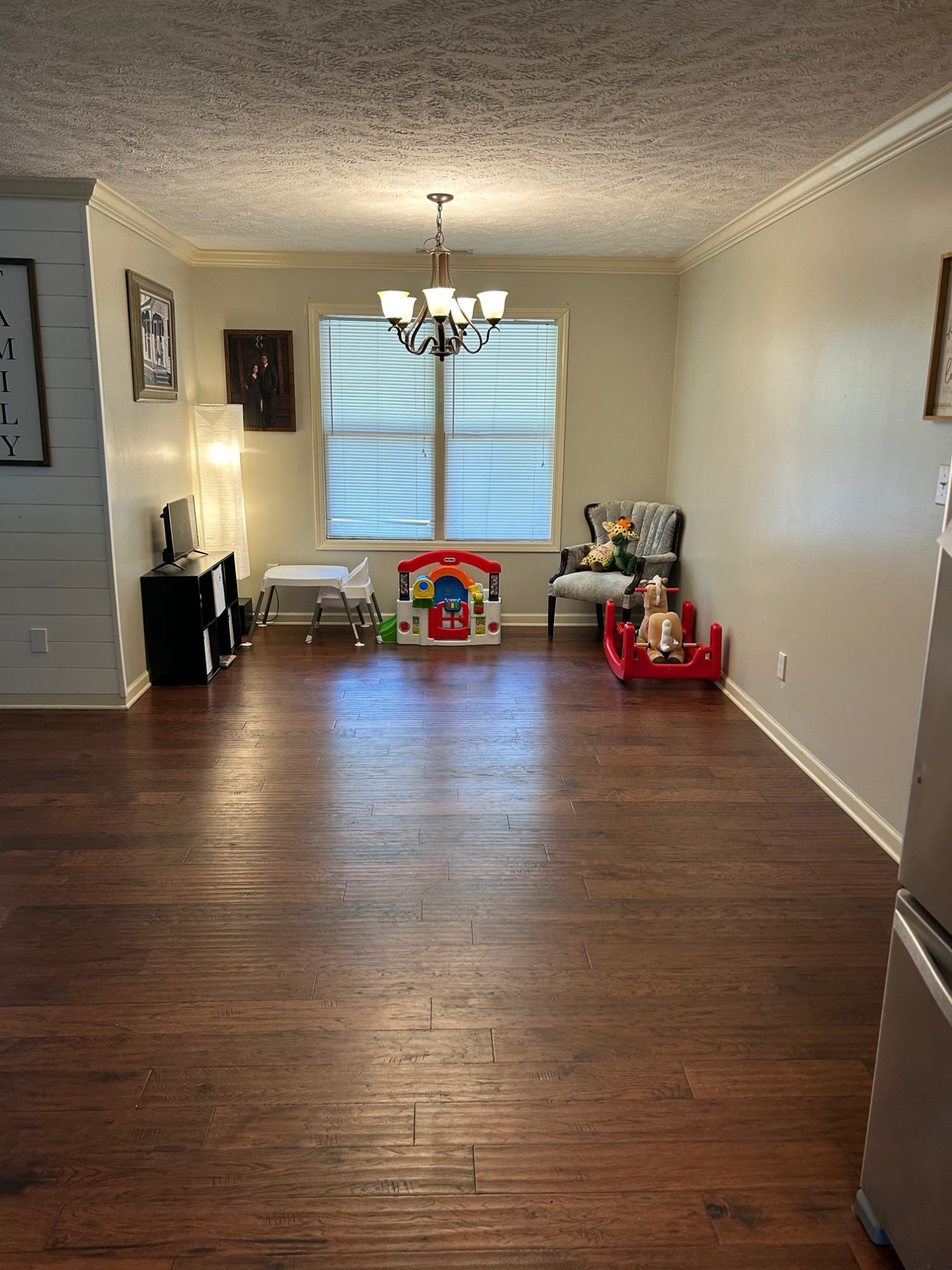 3250 Garland Road Pinson, TN 38366 - Photo 3 of 10 a view of a room with wooden floor and chandelier