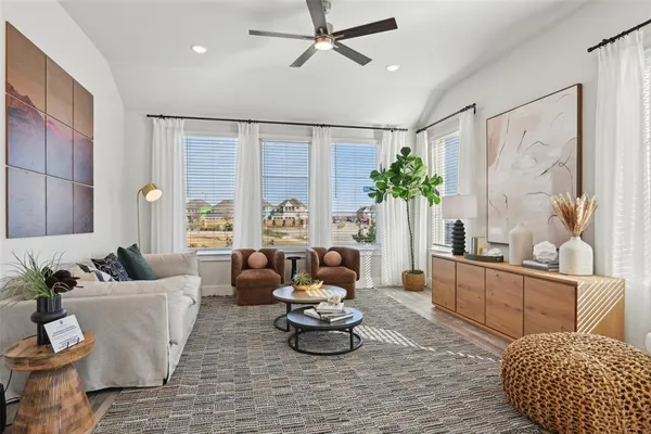 a living room with furniture and a potted plant