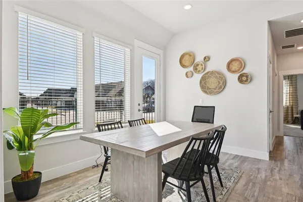 a view of a dining room with furniture and wooden floor