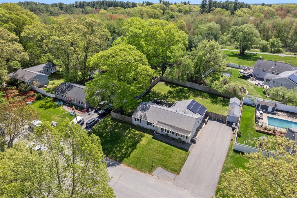 an aerial view of a house with a yard basket ball court and outdoor seating