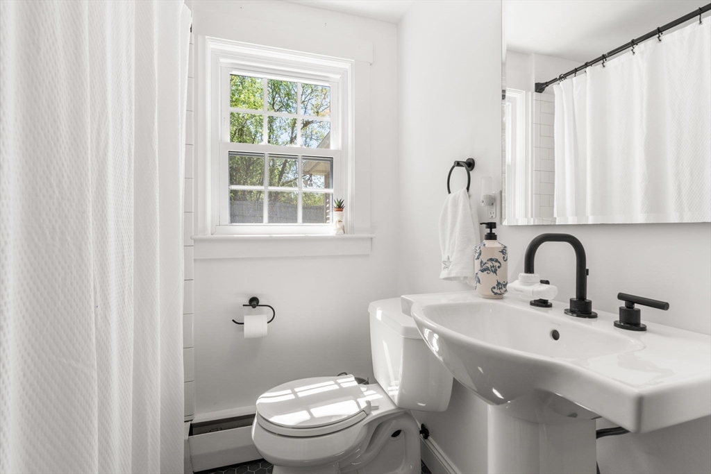 5 Eclipse Avenue Chelmsford, MA 01824 - Photo 14 of 25 a bathroom with a sink a toilet and a window
