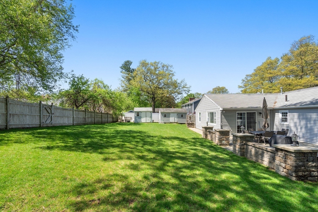 5 Eclipse Avenue Chelmsford, MA 01824 - Photo 20 of 25 a backyard of a house with table and chairs