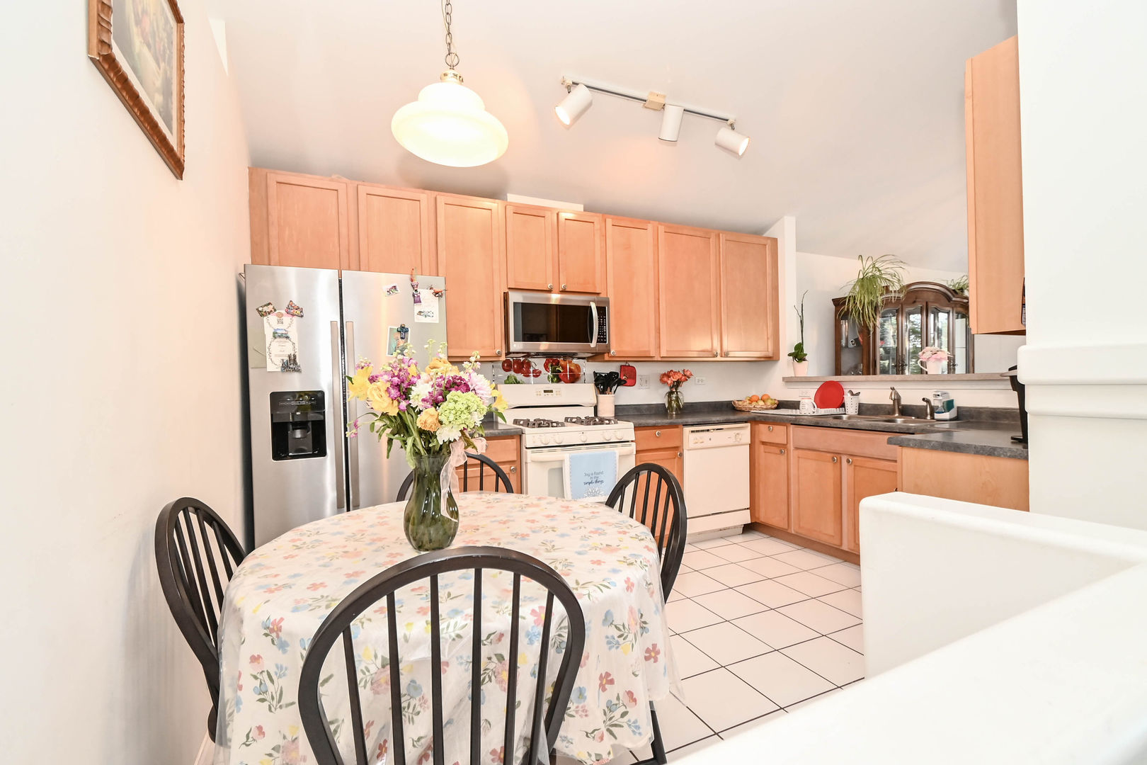 714 South Rosehall Lane Round Lake, IL 60073 - Photo 7 of 35 a kitchen with stainless steel appliances granite countertop a stove a refrigerator a kitchen island a stove and a dining table