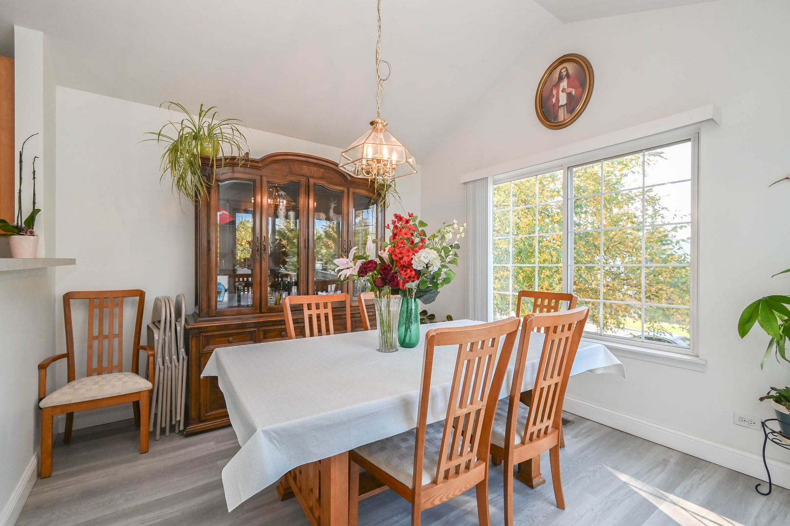 714 South Rosehall Lane Round Lake, IL 60073 - Photo 10 of 35 a dining room with furniture a potted plant and a chandelier