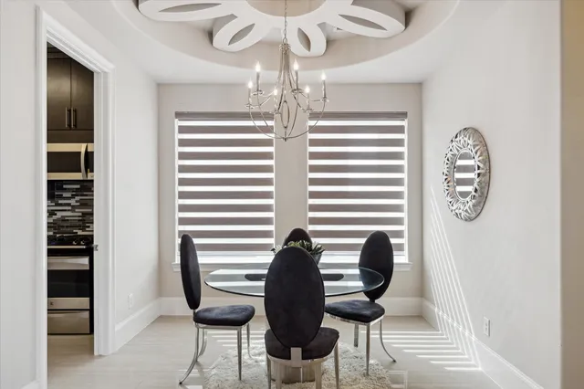a view of a room with furniture and chandelier