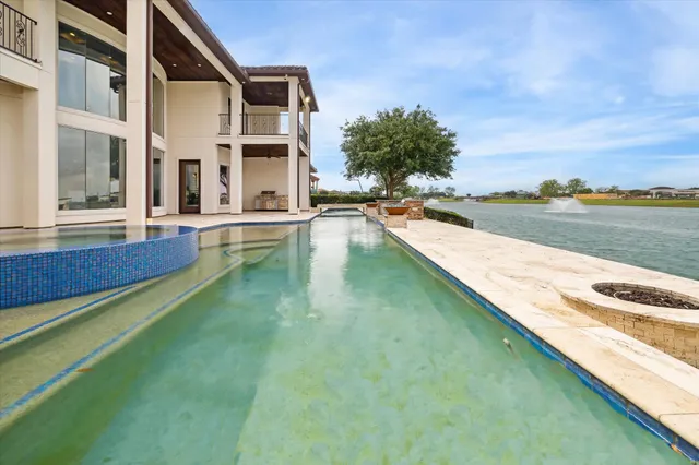 a view of swimming pool with outdoor space and seating area