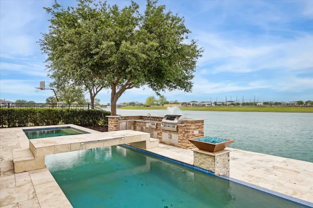 a view of a lake with couches and city view