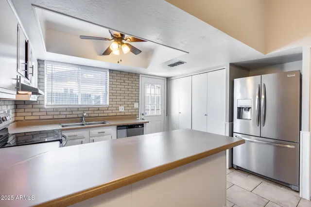 a kitchen with a sink stove and cabinets