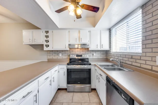 a kitchen with a refrigerator and cabinets