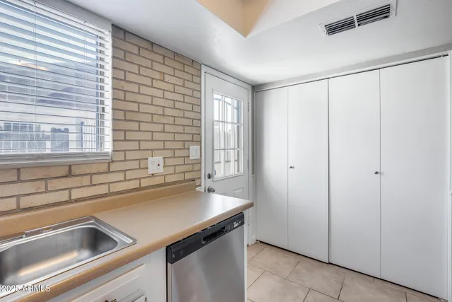 a view of a bathroom from a hallway with three rooms