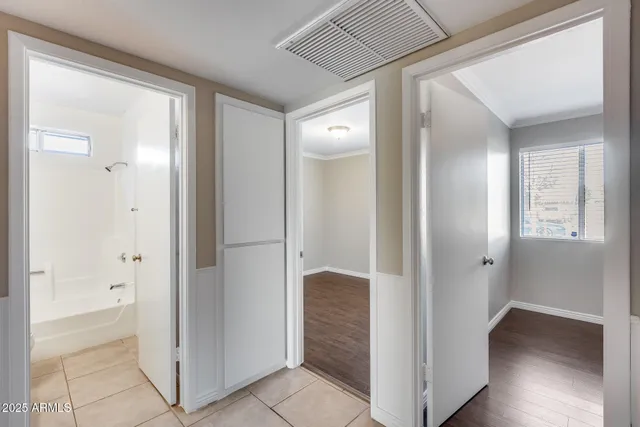 an empty room with closet and a chandelier fan