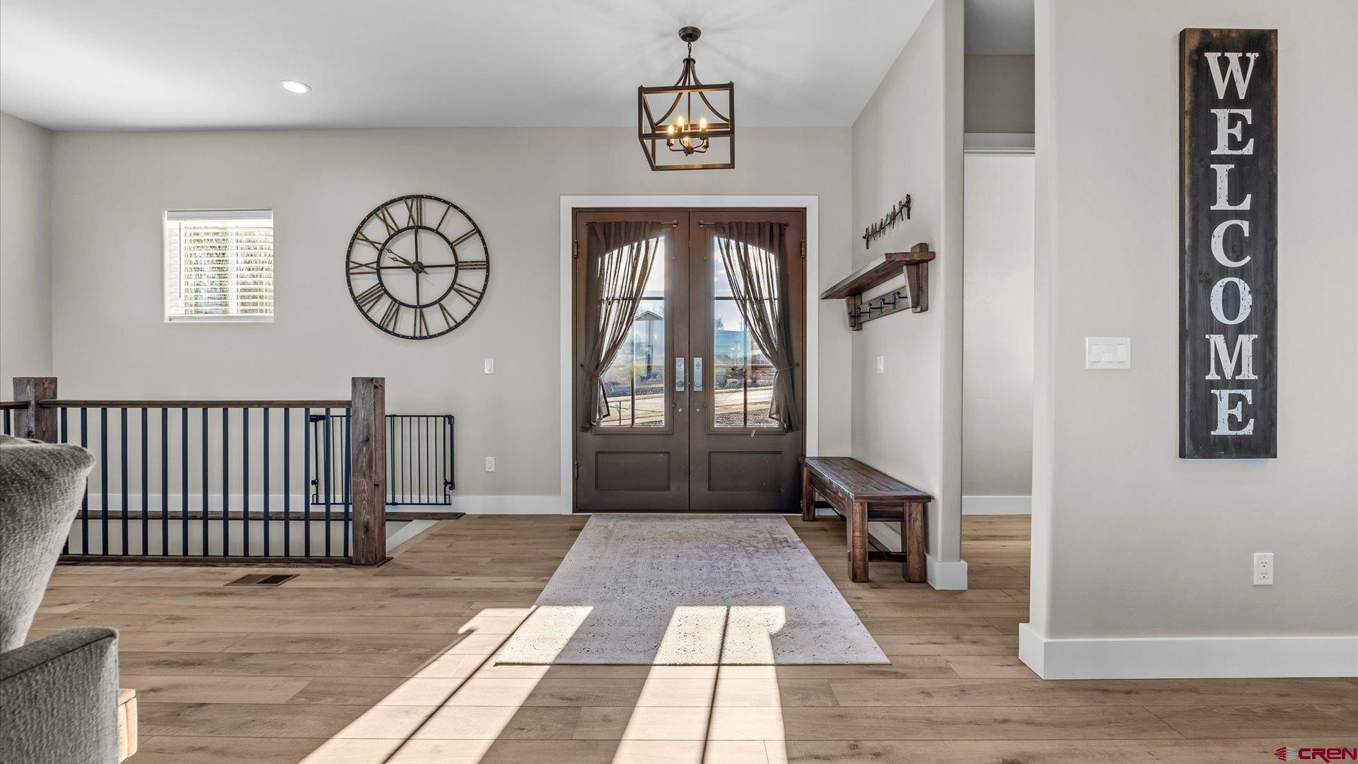 1774 Trapper Court Delta, CO 81416 - Photo 5 of 45 Beautiful double doors invite you into a grand open concept living, dining and kitchen area with vaulted ceiling.
