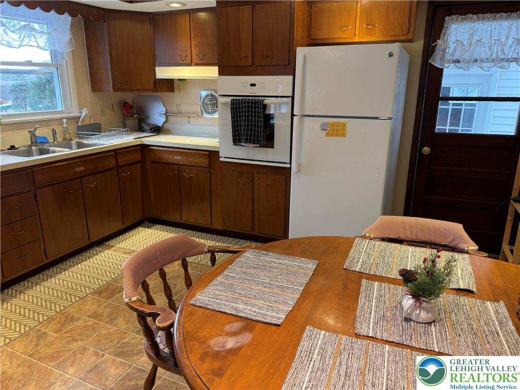 1445 Church Road Wind Gap, PA 18091 - Photo 17 of 37 a kitchen with a sink a stove and refrigerator