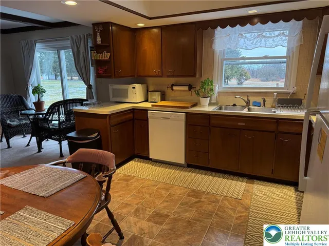 a kitchen with a sink cabinets and window