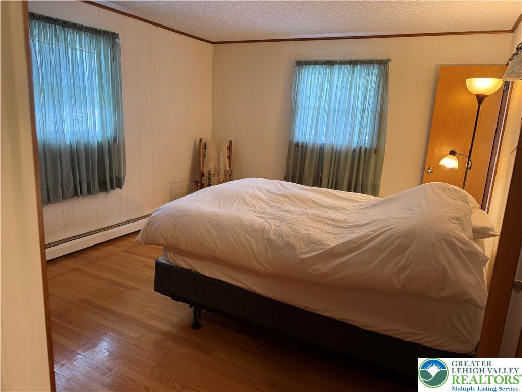1445 Church Road Wind Gap, PA 18091 - Photo 26 of 37 a bedroom with a bed and wooden floor