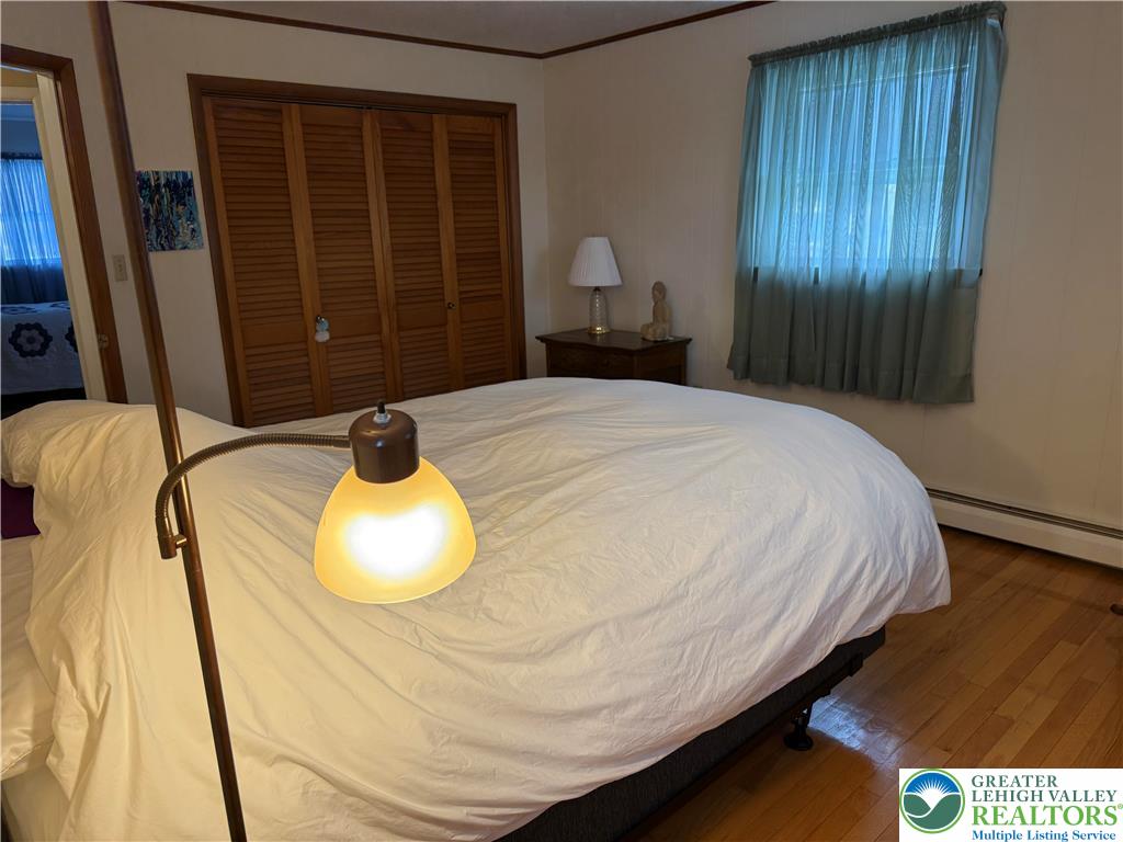 1445 Church Road Wind Gap, PA 18091 - Photo 27 of 37 a bedroom with a bed and wooden floor