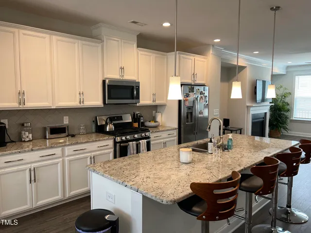 a kitchen with a sink a microwave a stove and refrigerator