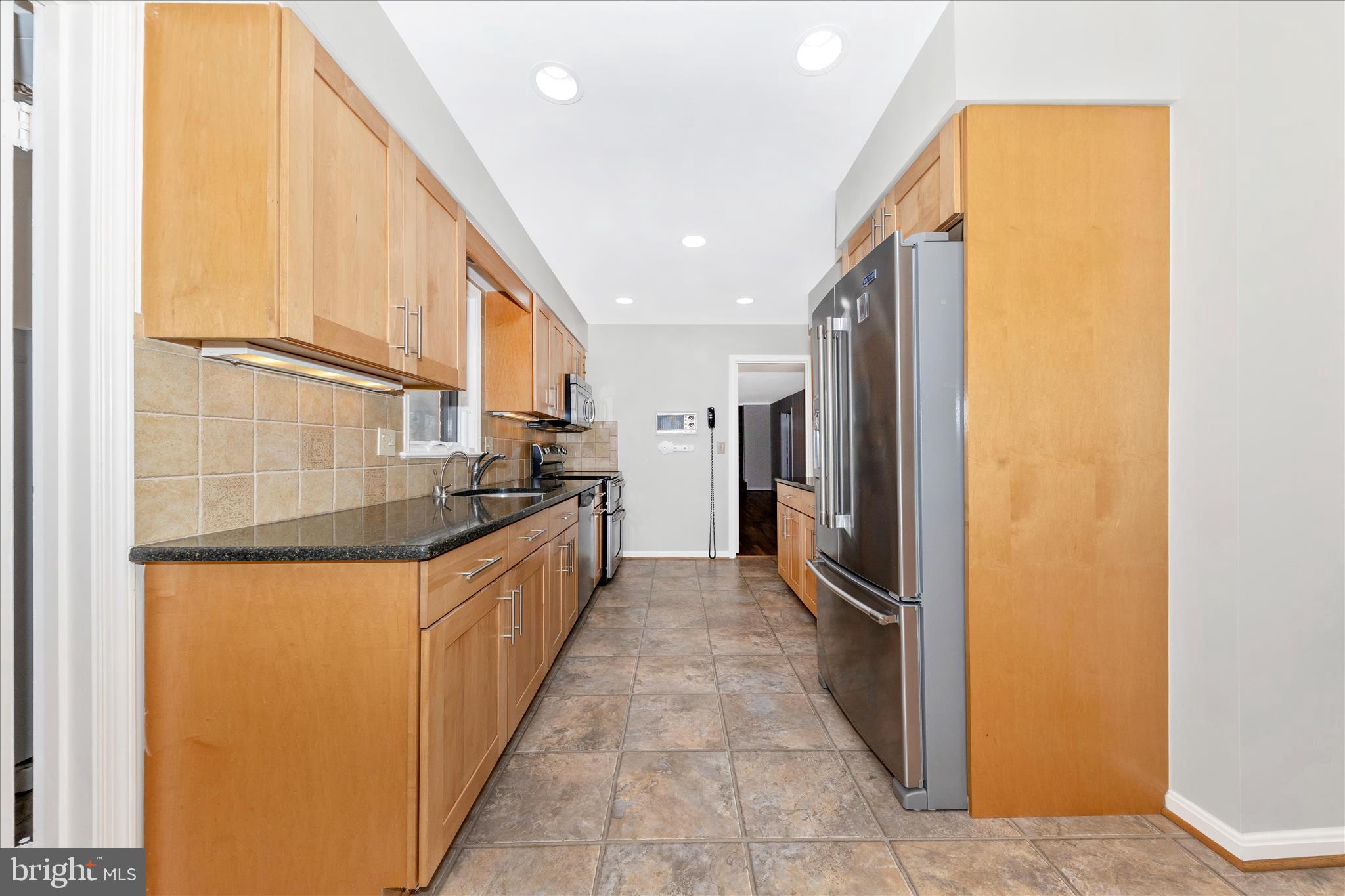 11806 Prestwick Road Potomac, MD 20854 - Photo 11 of 64 a kitchen with stainless steel appliances granite countertop a refrigerator and a sink