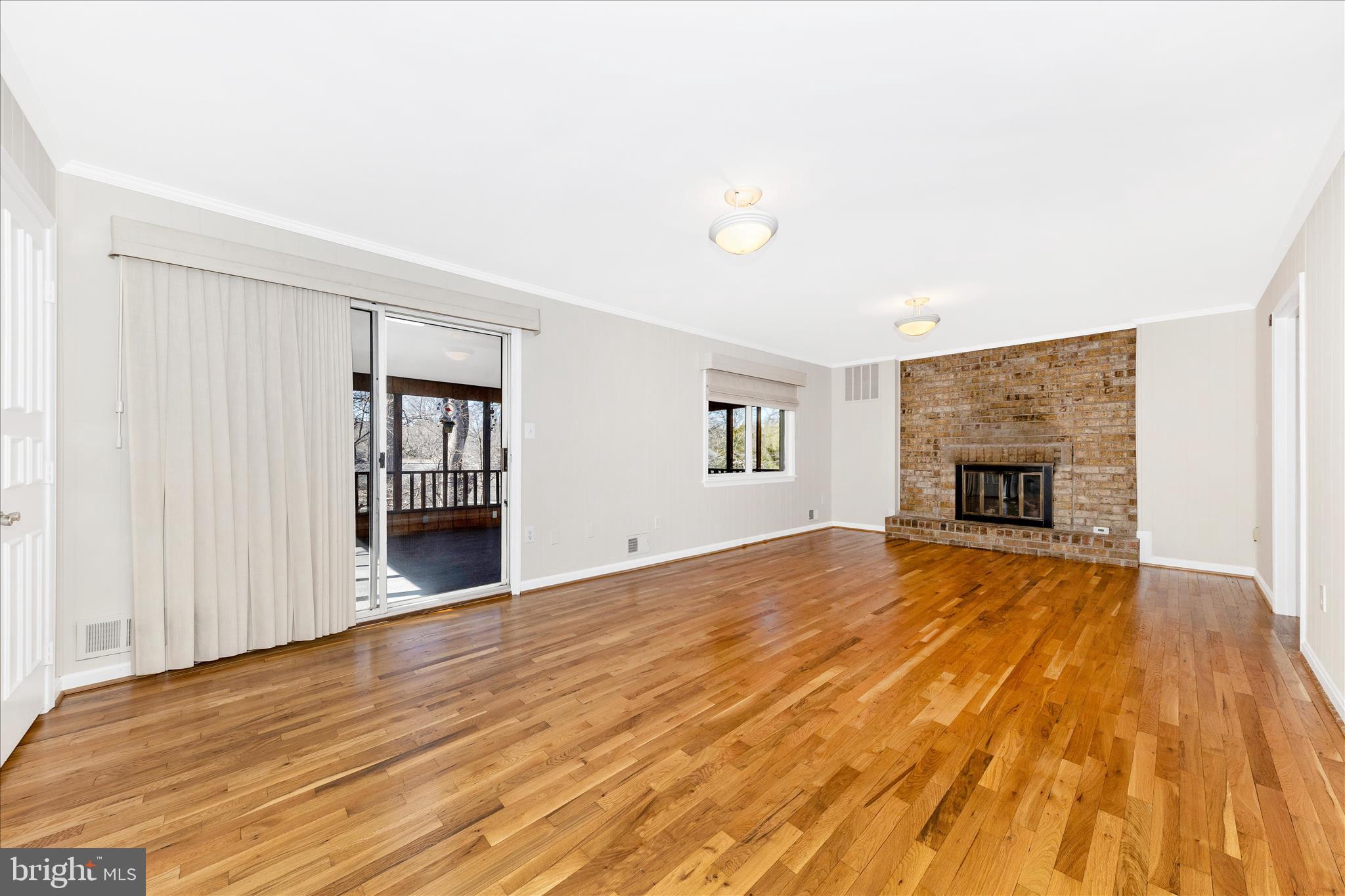 11806 Prestwick Road Potomac, MD 20854 - Photo 12 of 64 a view of empty room with wooden floor and fireplace
