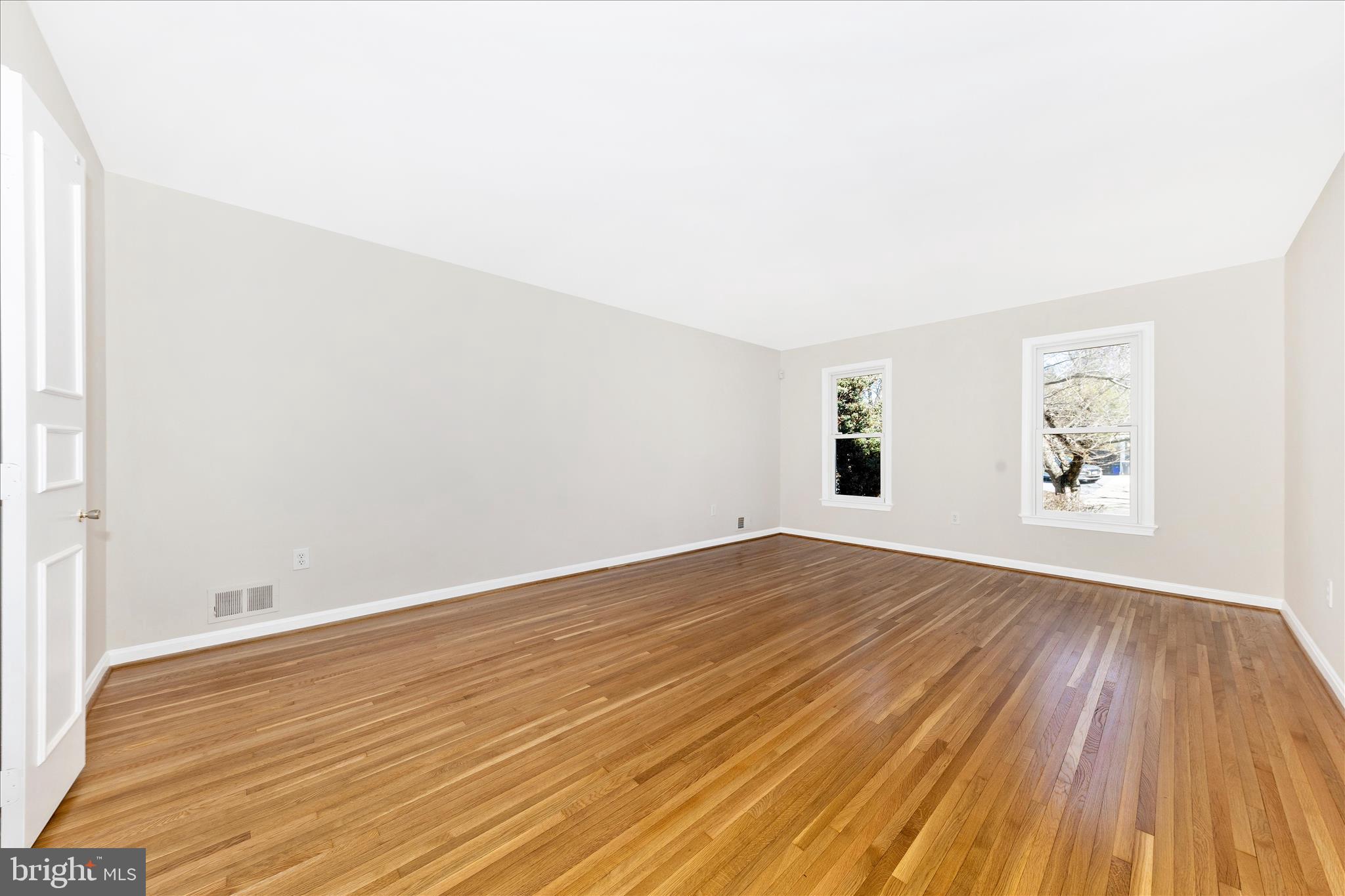 11806 Prestwick Road Potomac, MD 20854 - Photo 14 of 64 an empty room with wooden floor and windows
