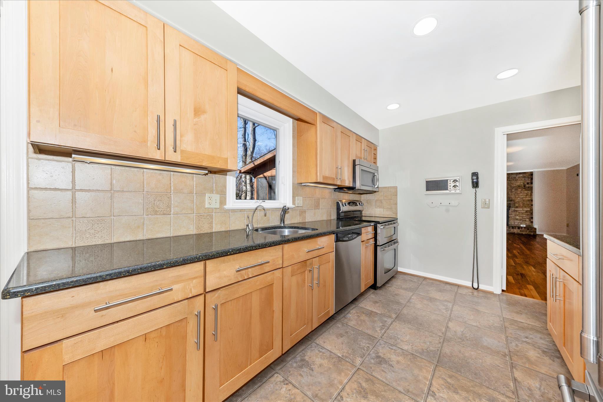 11806 Prestwick Road Potomac, MD 20854 - Photo 20 of 64 a kitchen with granite countertop white cabinets and stainless steel appliances