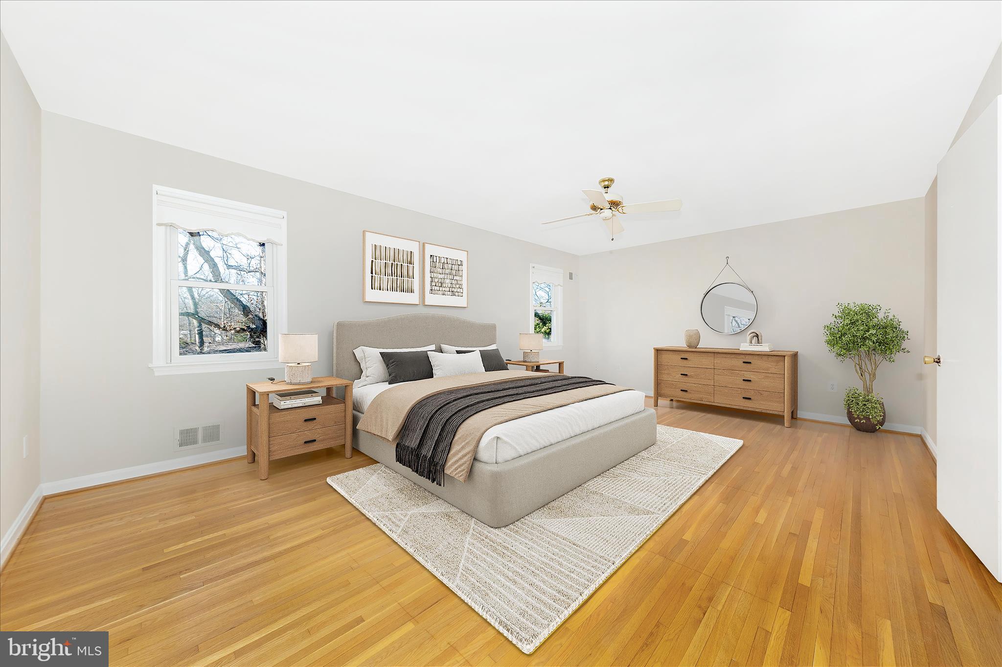 11806 Prestwick Road Potomac, MD 20854 - Photo 23 of 64 a spacious bedroom with a bed a dresser and potted plants