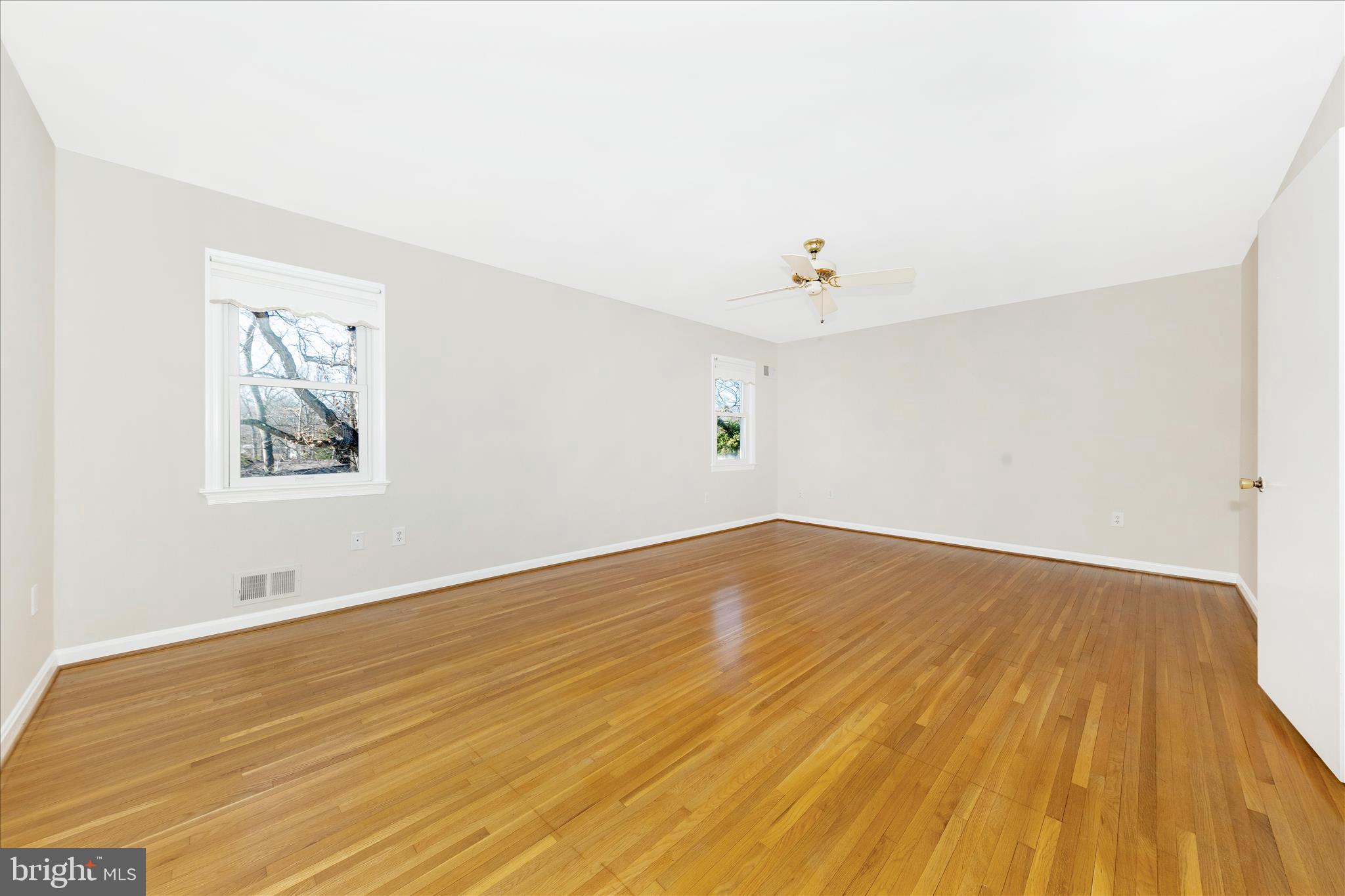11806 Prestwick Road Potomac, MD 20854 - Photo 29 of 64 a view of empty room with wooden floor and fan