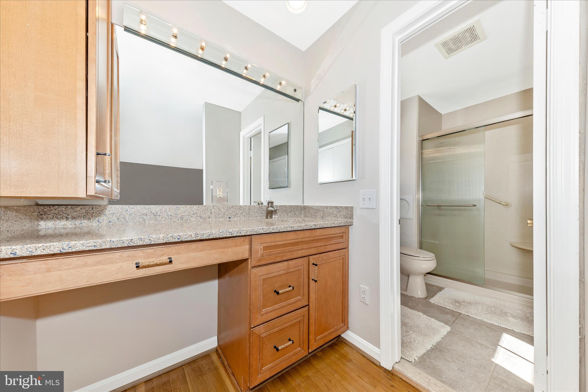 11806 Prestwick Road Potomac, MD 20854 - Photo 31 of 64 a spacious bathroom with a granite countertop sink mirror and a toilet
