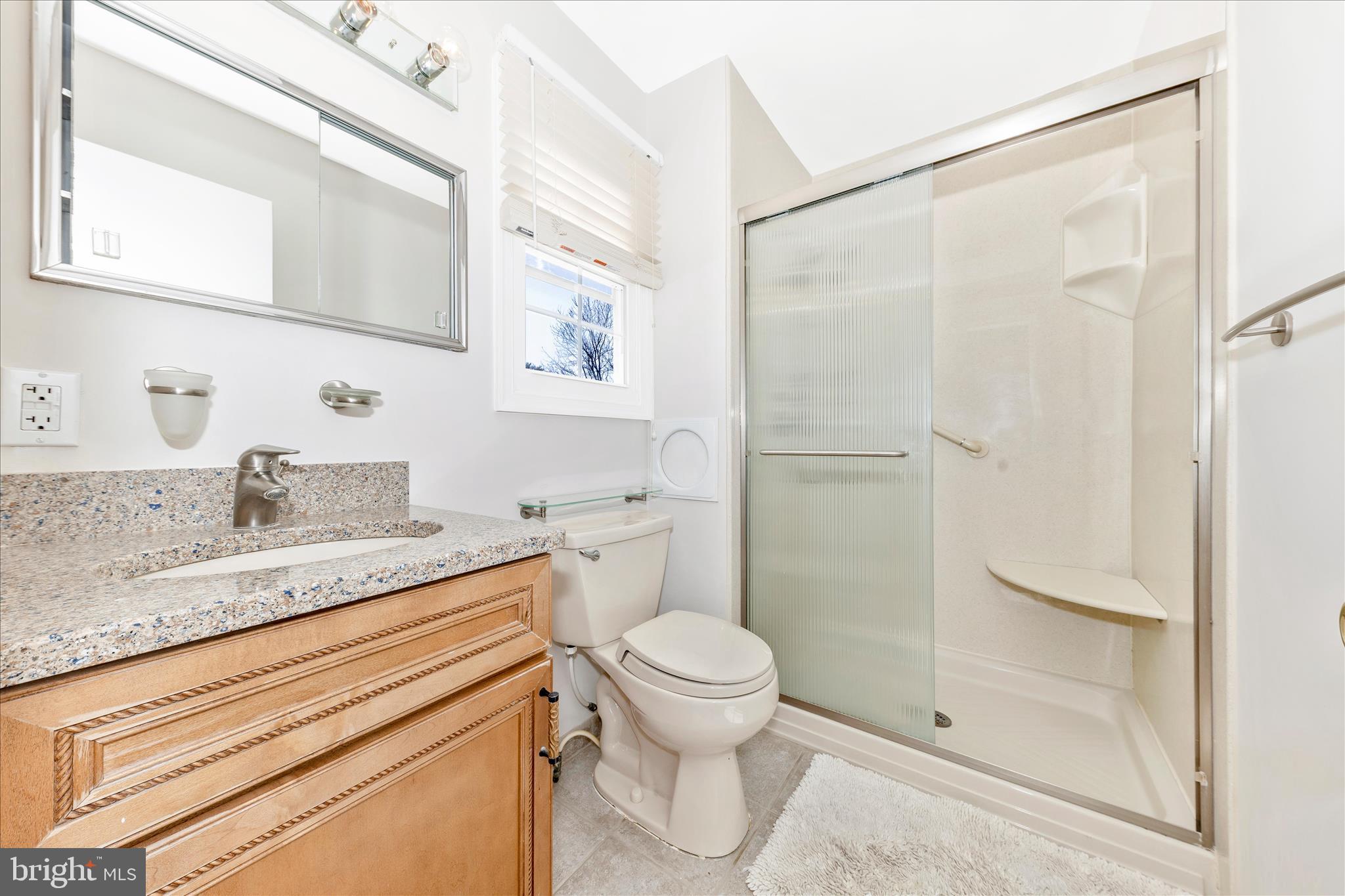11806 Prestwick Road Potomac, MD 20854 - Photo 32 of 64 a bathroom with a granite countertop sink toilet and shower