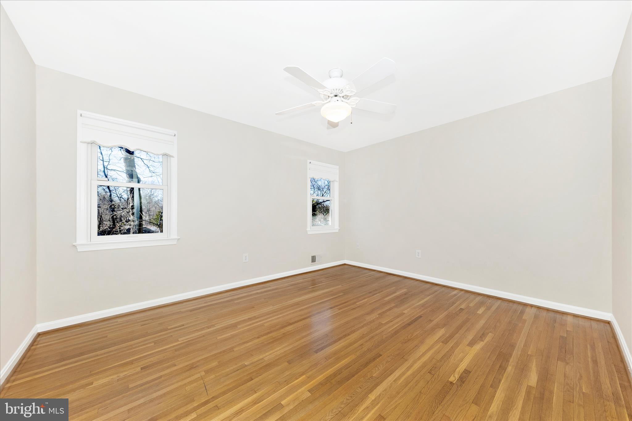 11806 Prestwick Road Potomac, MD 20854 - Photo 37 of 64 an empty room with wooden floor and windows