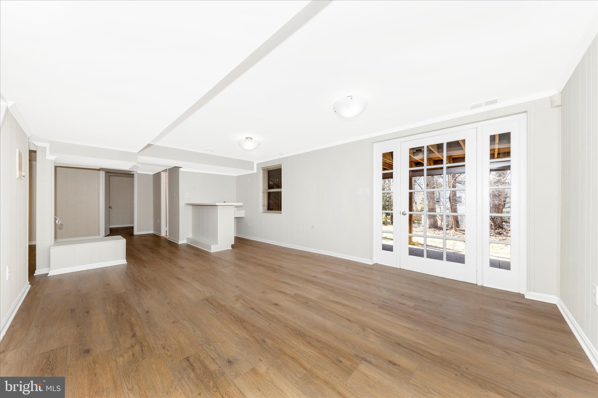 11806 Prestwick Road Potomac, MD 20854 - Photo 39 of 64 a view of an empty room with wooden floor and a window