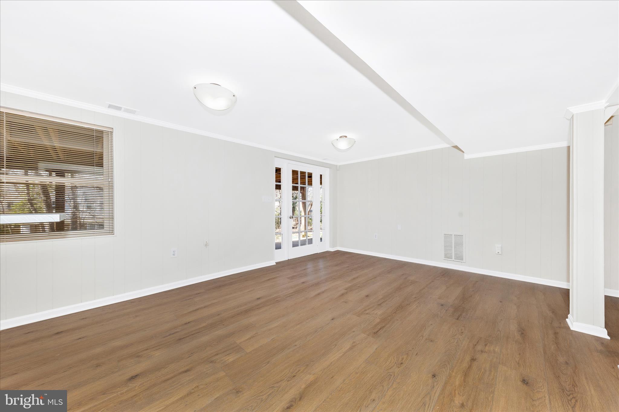11806 Prestwick Road Potomac, MD 20854 - Photo 43 of 64 an empty room with wooden floor and windows