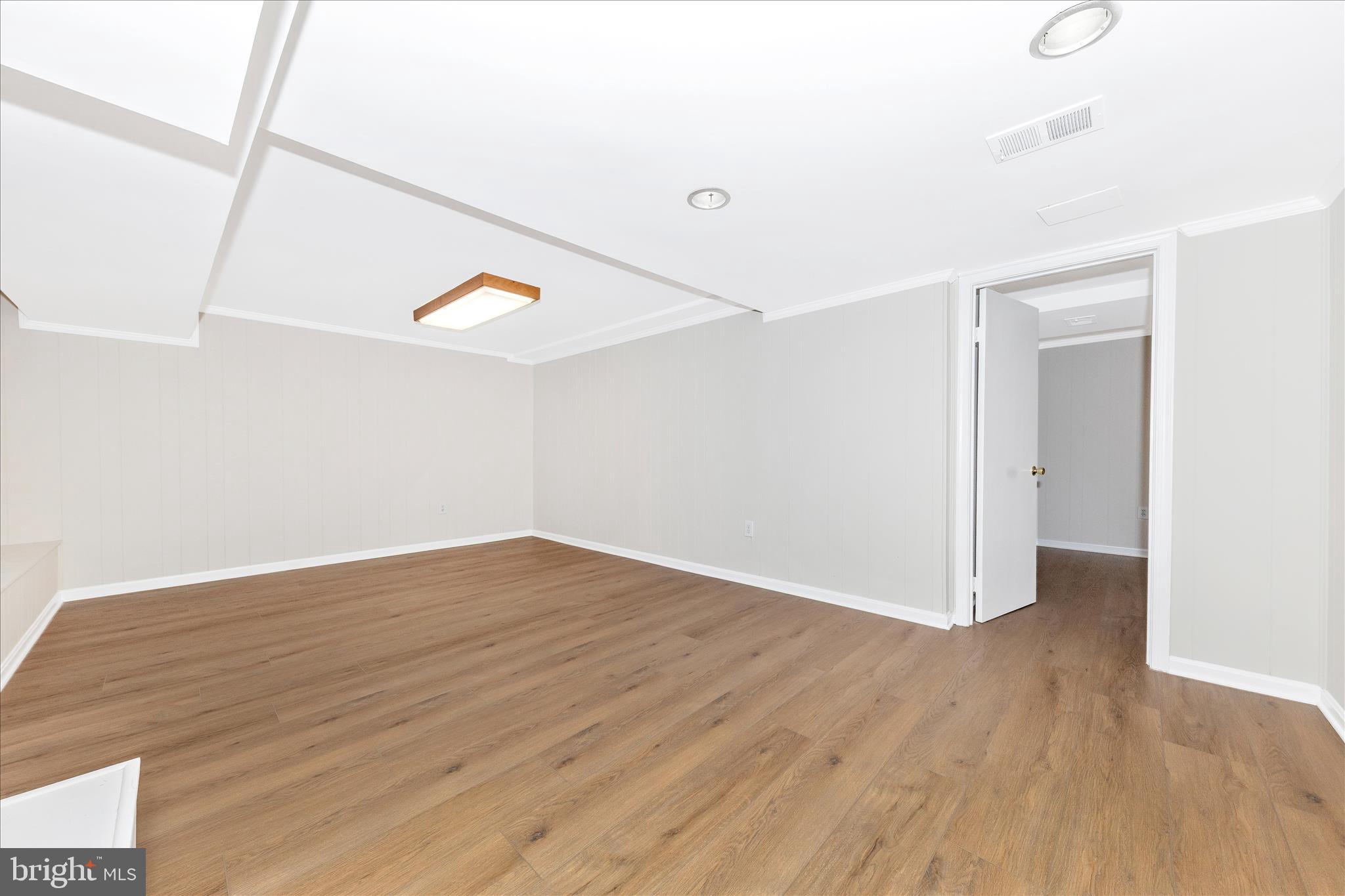 11806 Prestwick Road Potomac, MD 20854 - Photo 44 of 64 a view of an empty room with wooden floor