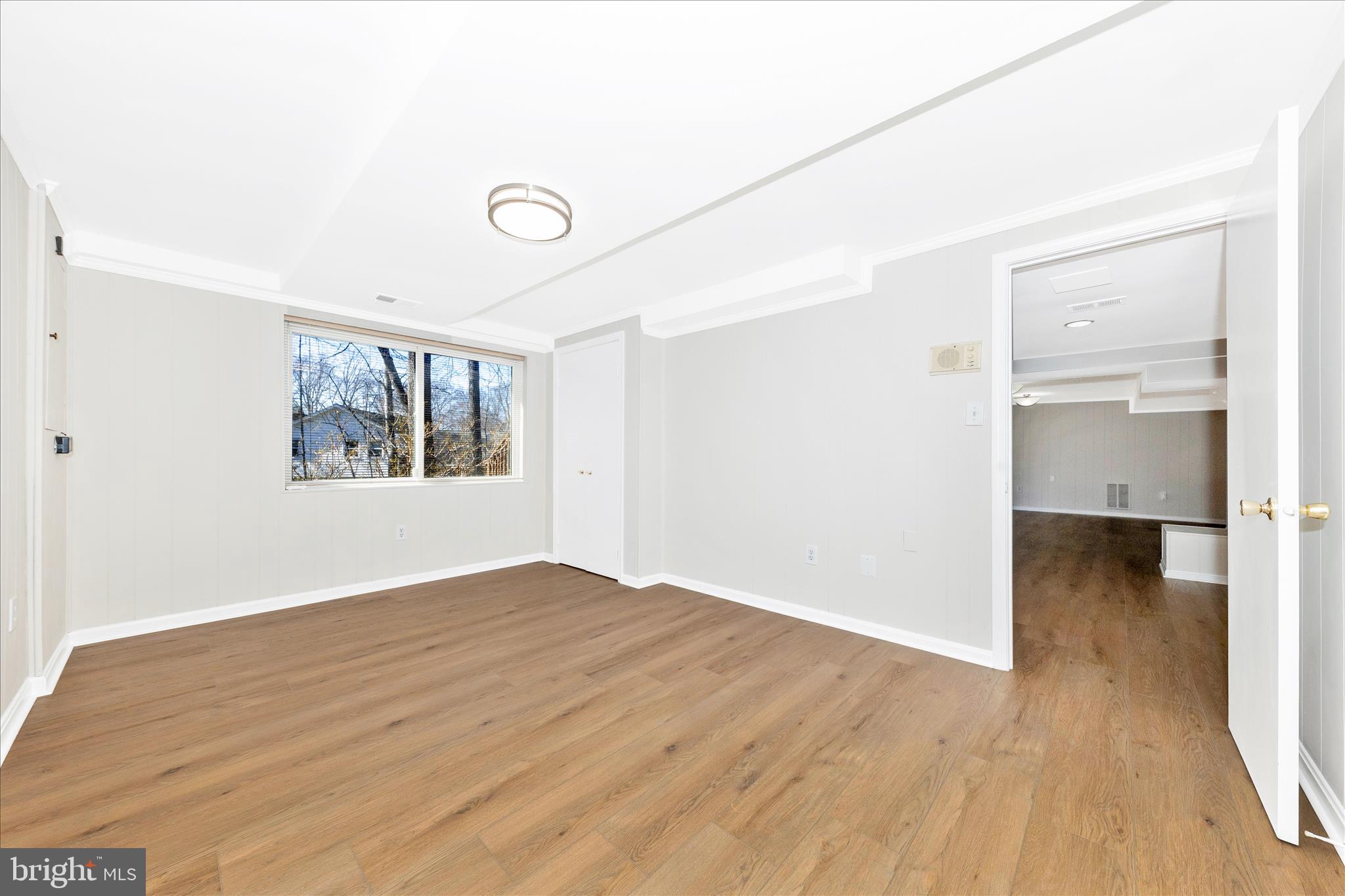 11806 Prestwick Road Potomac, MD 20854 - Photo 49 of 64 an empty room with wooden floor cabinet and windows