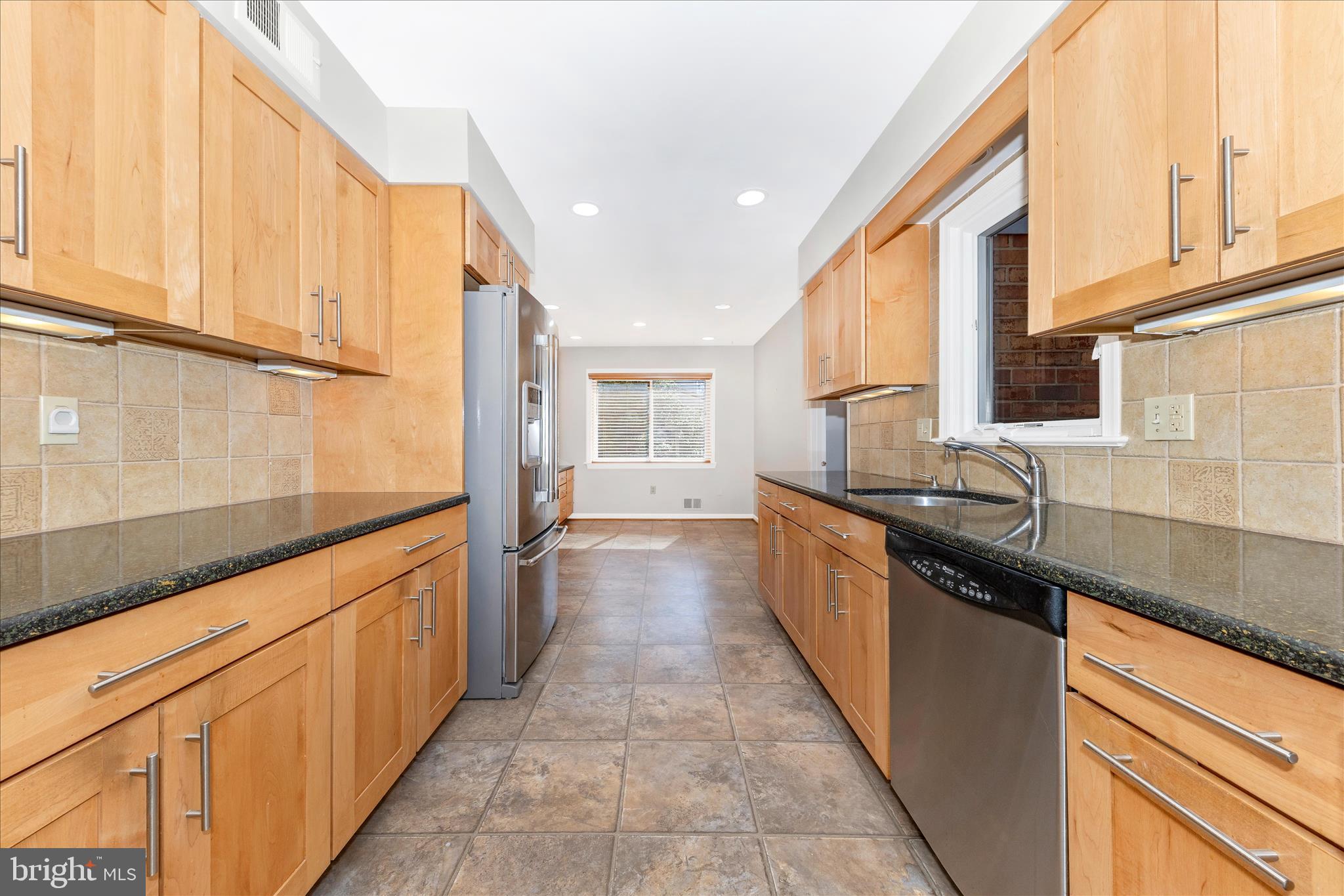 11806 Prestwick Road Potomac, MD 20854 - Photo 9 of 64 a large kitchen with stainless steel appliances granite countertop a sink and a stove top oven