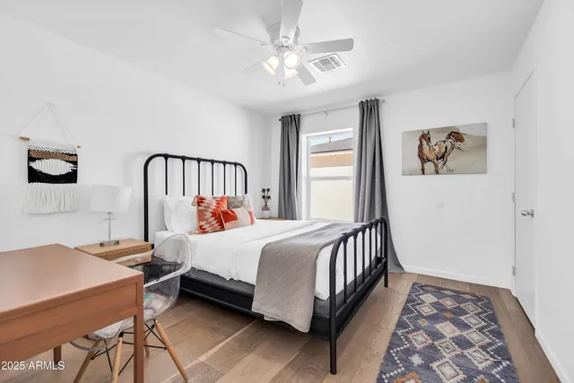 a bedroom with a bed and a view of kitchen