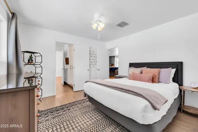 a bedroom with a bed couch and window