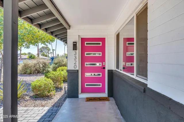 a living room with furniture kitchen view and a large window