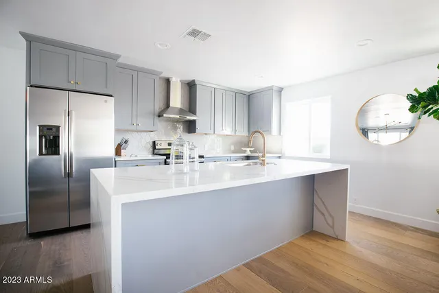 a bathroom with a sink mirror and vanity