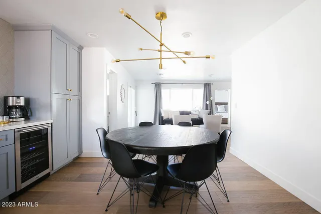 a front view of a house with a garden and tree