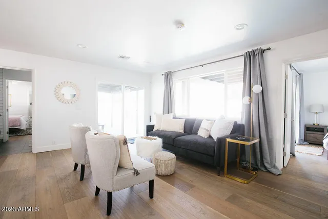 a view of a porch with furniture and a yard