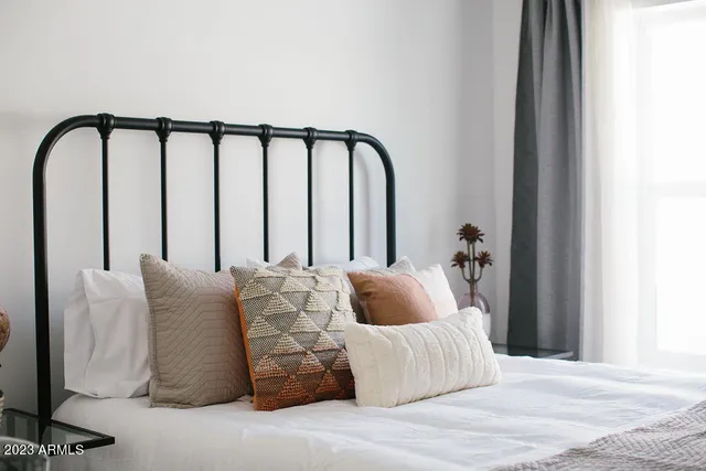 a bedroom with a bed and window