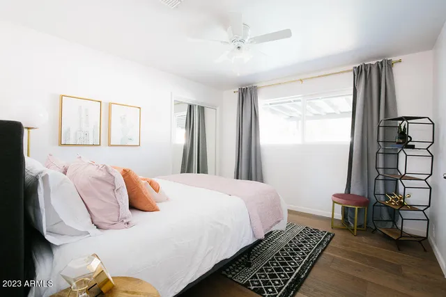 a kitchen with stainless steel appliances granite countertop a sink a stove a refrigerator cabinets and a window