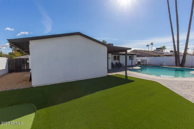 a living room with furniture a ceiling fan and a window