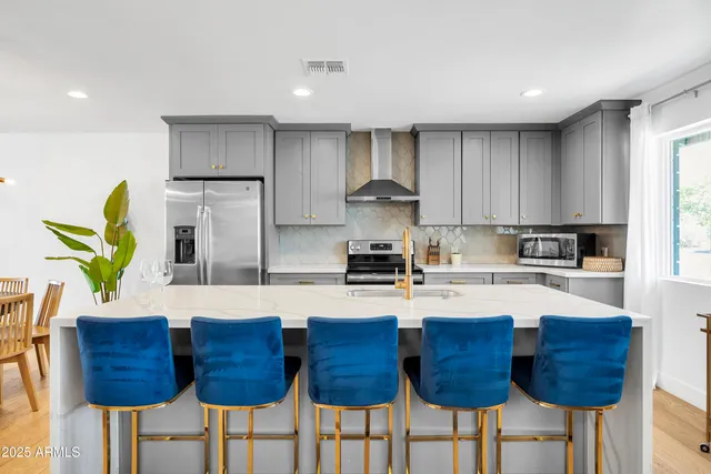 a close view of a sink and a potted plant on a counter