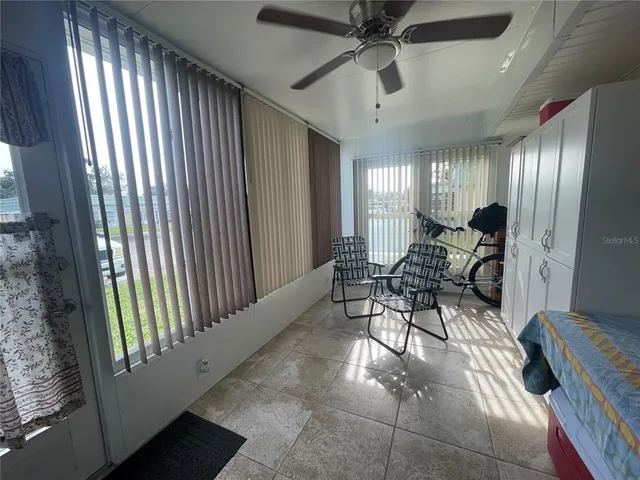 a view of a livingroom with furniture and a ceiling fan