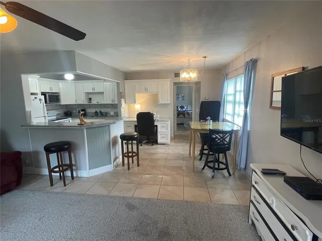 a kitchen with stainless steel appliances kitchen island granite countertop a sink and cabinets