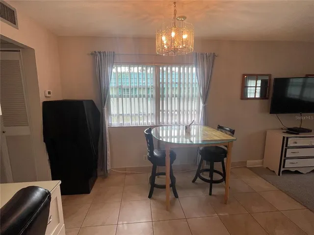 a view of a dining room with furniture and a window